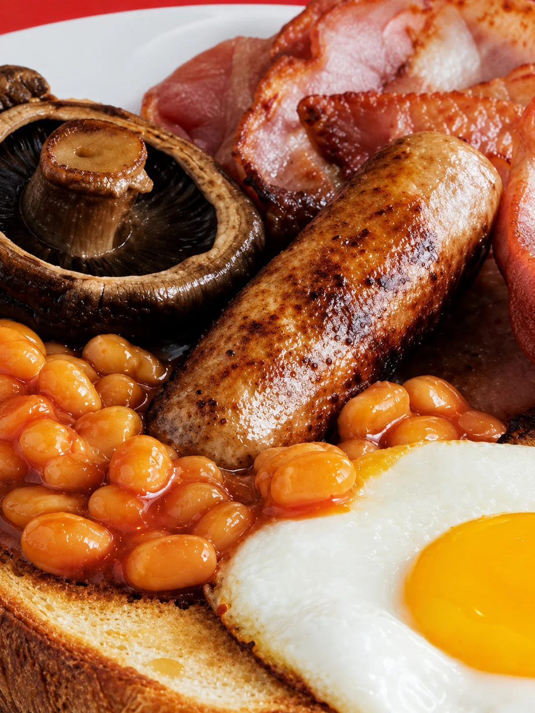 Full English breakfast with bacon, sausage, egg, beans, mushrooms and toast