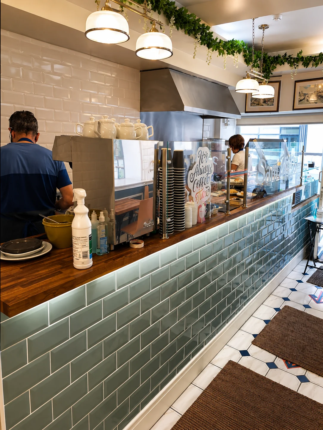 Sam Zair's Cafe counter with coffee equipment and pendant lights