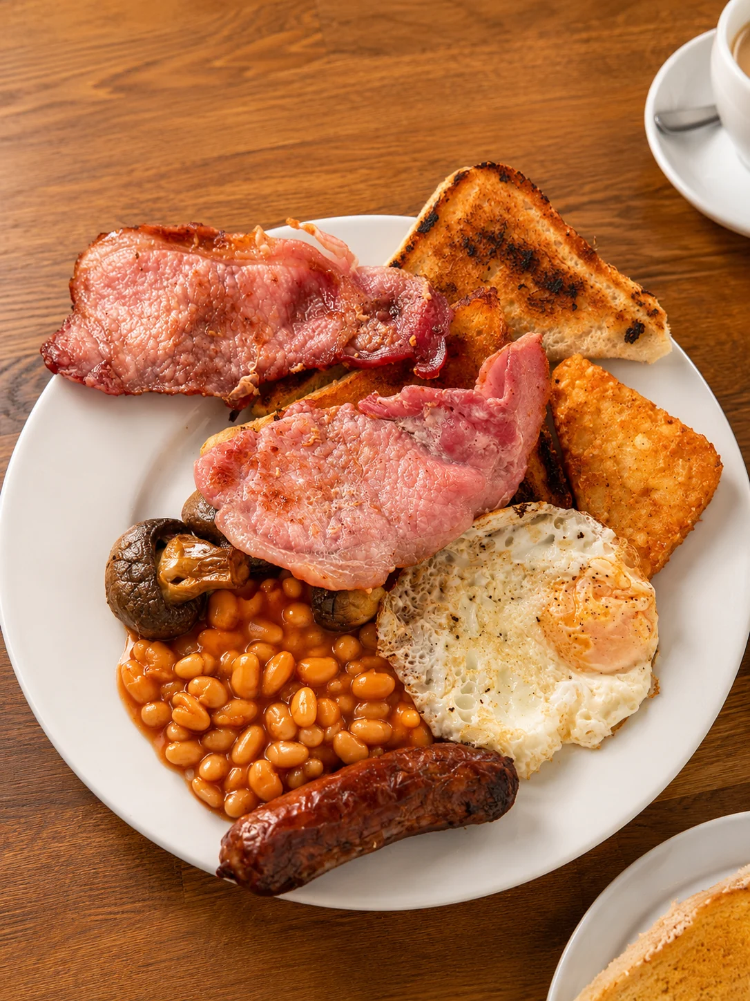 A full English breakfast with bacon, sausage, egg, beans, mushrooms and toast