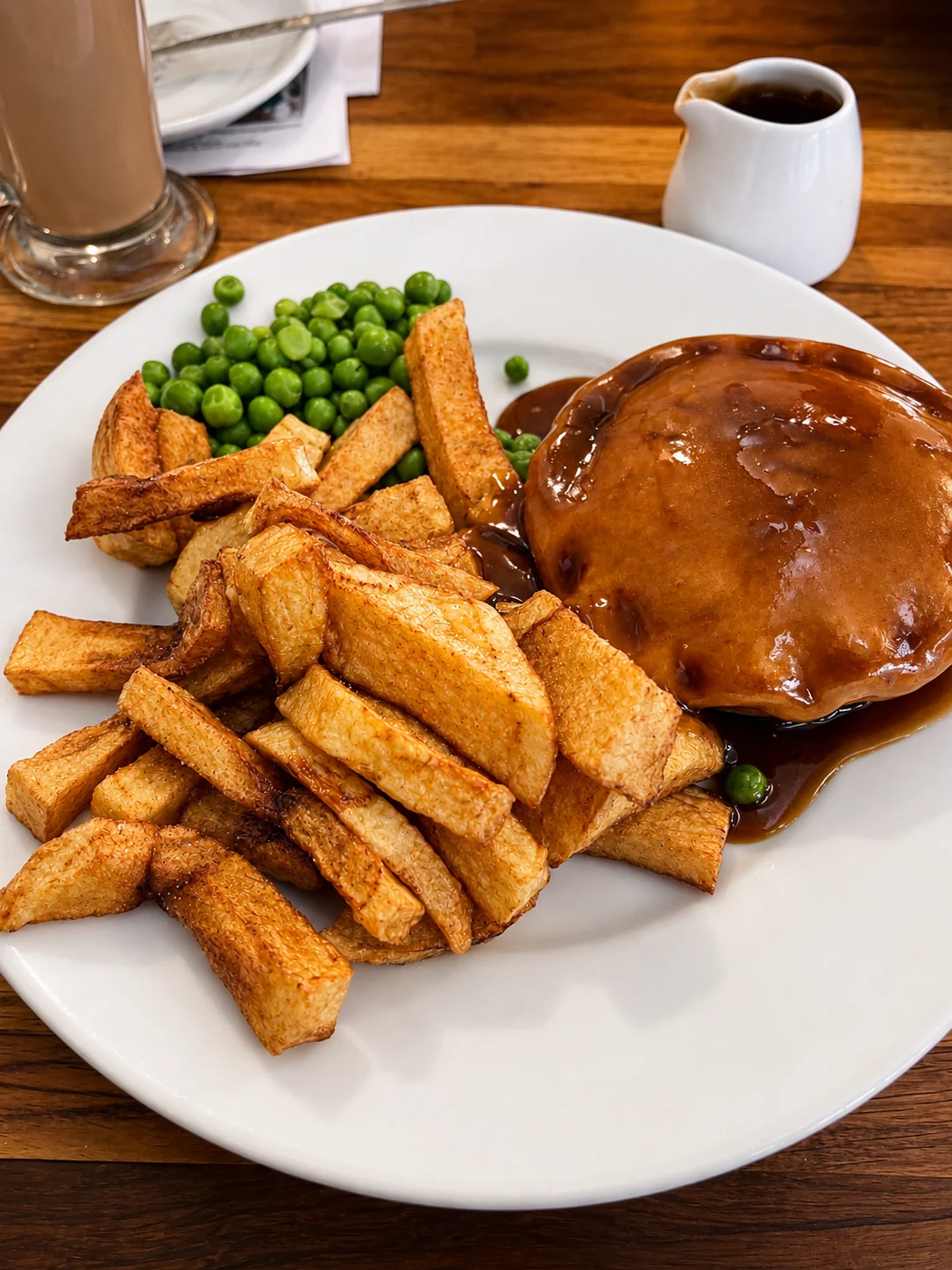 Pie served with chips, peas and gravy